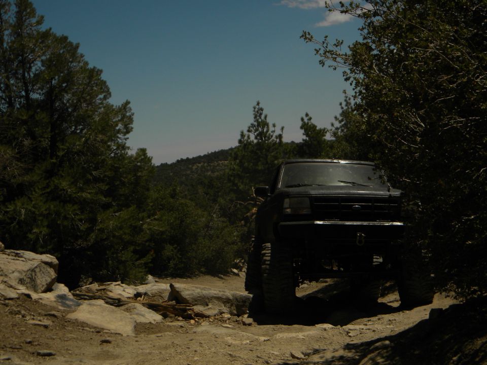 Black 1992 Ford Bronco on a rocky trail