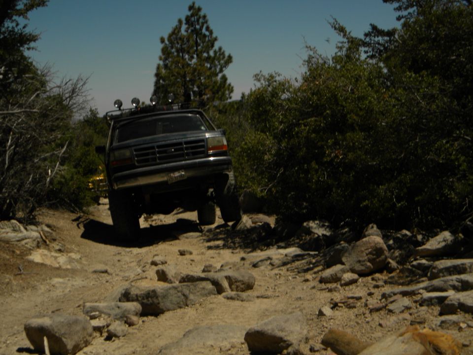 Ford F-Series truck driving on a rocky trail