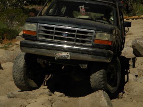 1992 Ford Bronco - A 1992 Ford Bronco navigates a challenging rocky path, demonstrating its off-road capabilities.