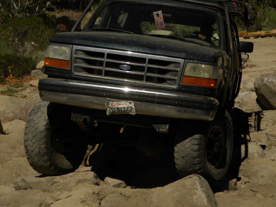 Dark green 1992 Ford Bronco on rocky terrain, front view