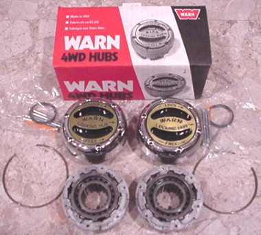 1996 Ford Bronco - Two Warn 4WD locking hubs and associated parts are displayed with their original packaging.