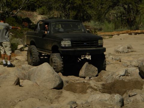 1992 Ford Bronco - This lifted black 1992 Ford Bronco navigates a rocky off-road course.