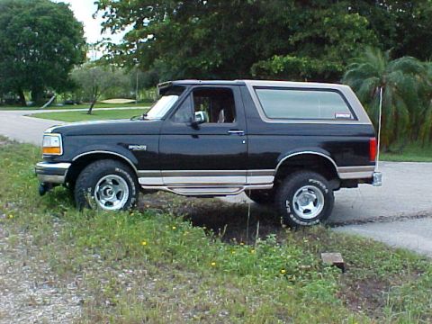 1996 Ford Bronco - This 1996 Ford Bronco features a two-tone paint scheme with a black lower body and a tan removable top.