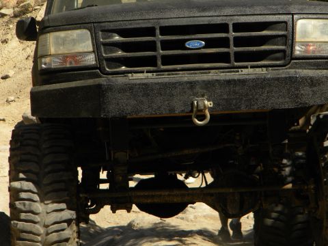 1992 Ford Bronco - Front view of a black 1992 Ford Bronco, modified with a heavy-duty bumper and off-road tires.