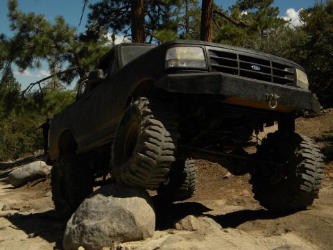 1992 Ford Bronco - This 1992 Ford Bronco is navigating a rocky trail with its front tires elevated.