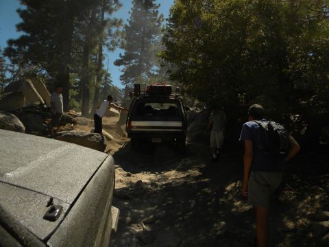 1992 Ford Bronco - A 1992 Ford Bronco navigates a challenging rocky trail with several people present.