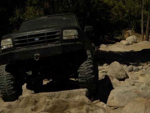 1992 Ford Bronco - This 1992 Ford Bronco is shown off-roading over a challenging rocky path.