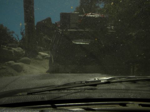 1992 Ford Bronco - A view from inside a dusty vehicle shows another off-road vehicle in a rocky, wooded outdoor scene.