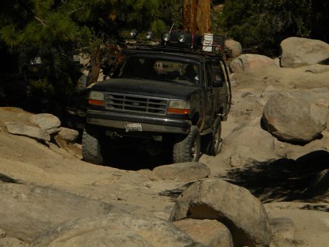 1992 Ford Bronco - This black 1992 Ford Bronco navigates a challenging rocky terrain, its off-road capabilities.
