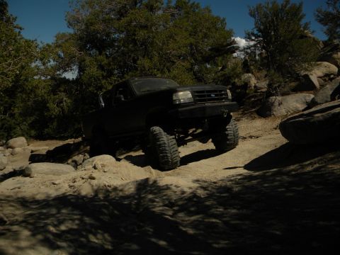 1992 Ford Bronco - This lifted 1992 Ford Bronco navigates a challenging off-road course with large tires and a stance.