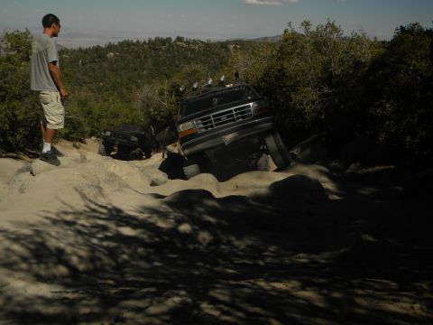 1992 Ford Bronco - A 1992 Ford Bronco tackles a challenging rocky trail with another vehicle visible in the background.