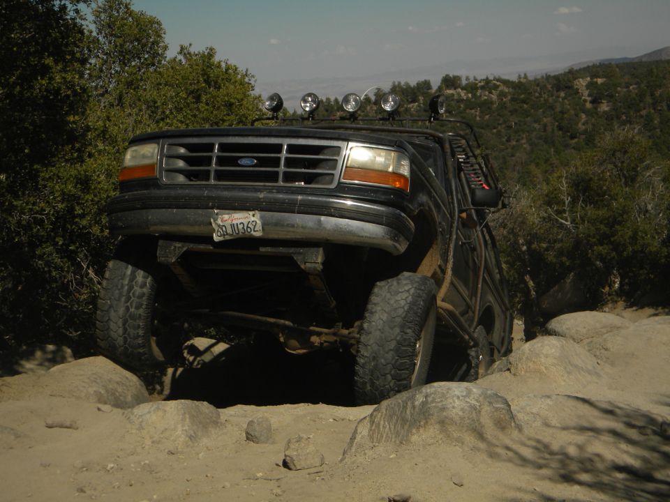 Black 1992 Ford Bronco on rocky terrain, front view