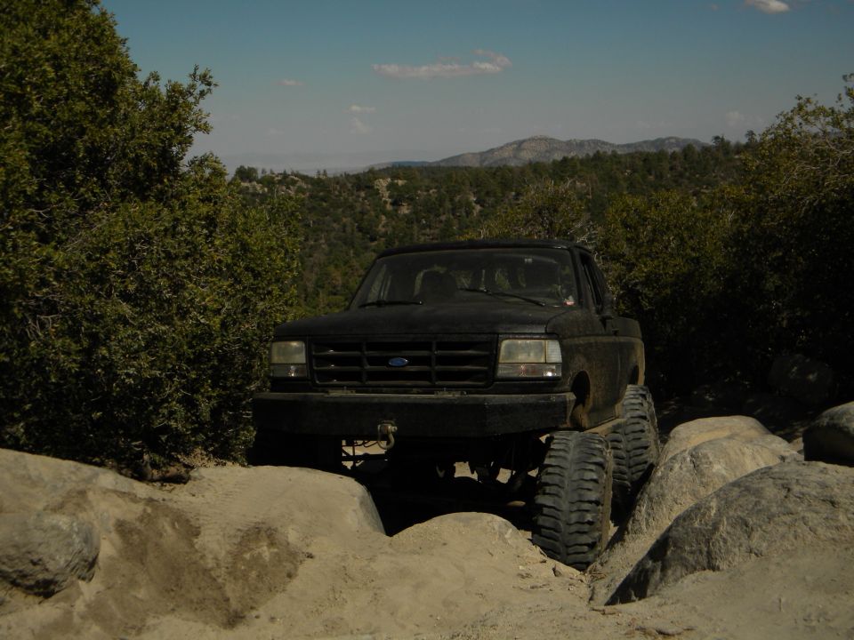 Black 1992 Ford Bronco on a rocky trail, front view