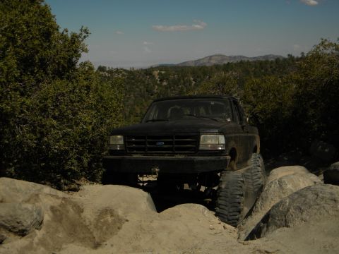 Black 1992 Ford Bronco navigating rocks on a trail