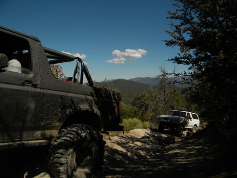 1992 Ford Bronco and another Bronco on a mountain trail