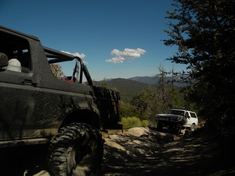 1992 Ford Bronco and another Bronco on a mountain trail