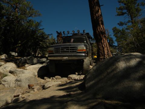 1992 Ford Bronco front view on rocky trail with roof lights