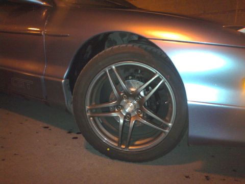 1994 Ford Probe - Close-up of the front wheel and fender of a 1994 Ford Probe GT.
