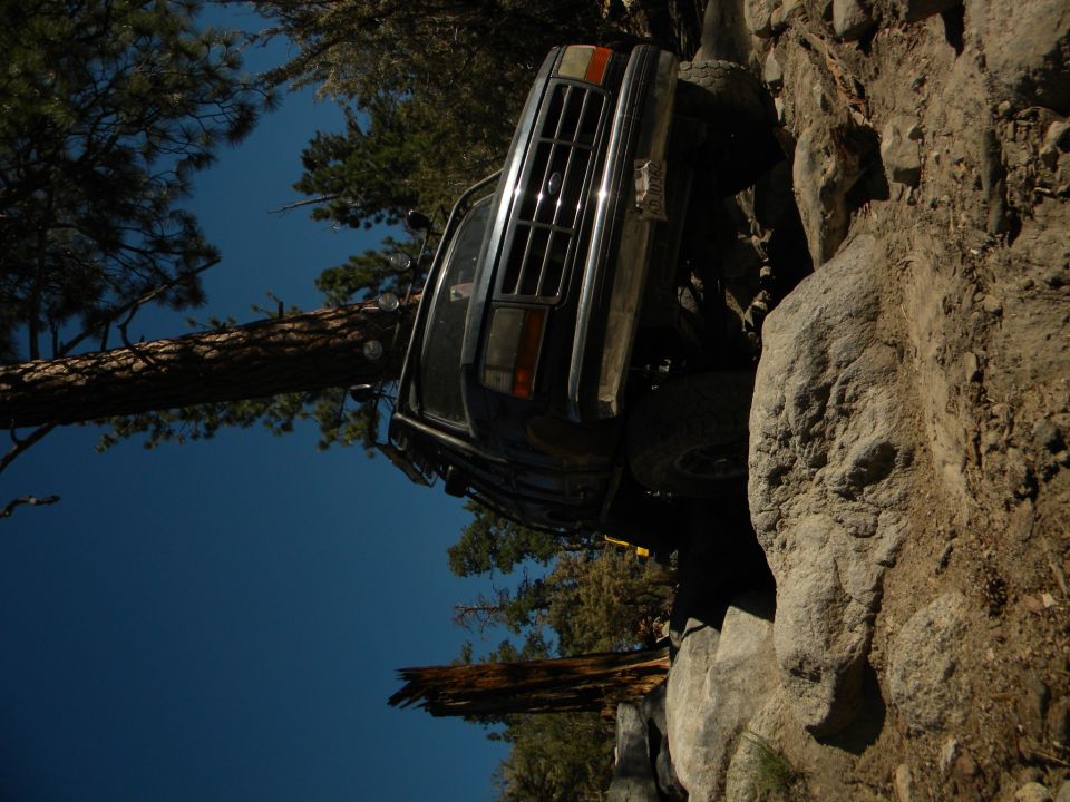 Dark 1992 Ford Bronco climbing rocks