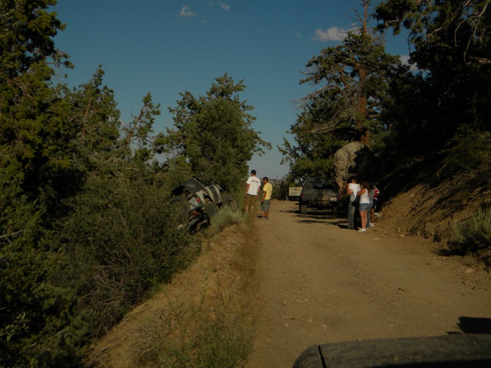Off-road vehicle tipped on its side on a dirt road