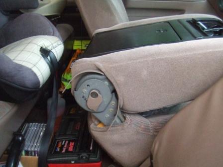 1996 Ford Bronco - The interior of a vehicle is shown, with seats and various items stored in the back.