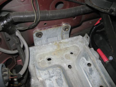1996 Ford Bronco - Vehicle battery tray and associated wiring, viewed from above.