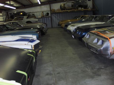1979 Chevrolet Camaro - Multiple vehicles are stored inside a garage, with some appearing to be in various states of repair.