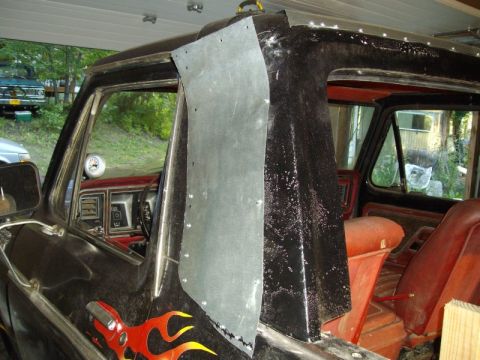 1978 Ford Bronco - Interior view of a 1978 Ford Bronco, custom metalwork and flame decals on the door panel.