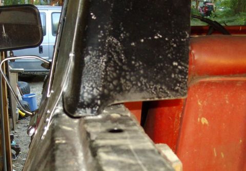 1978 Ford Bronco - Close-up view of the interior of a vehicle, showing a black panel and orange seating.