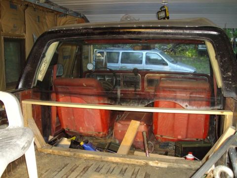 1978 Ford Bronco - Interior view of a 1978 Ford Bronco, with a van seen in the background.