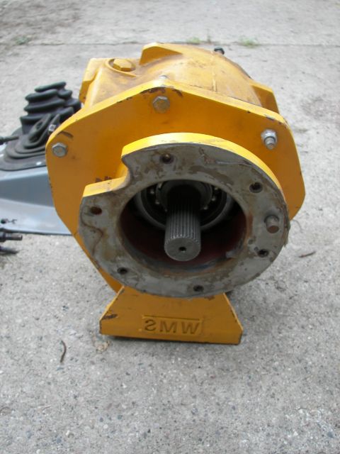 1988 Ford Bronco - This yellow transfer case has a visible shifter boot and a splined output shaft.