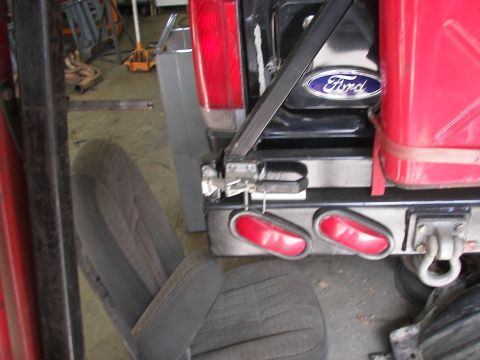1988 Ford Bronco - The Ford emblem is visible on the rear of the vehicle, next to a red gas can.