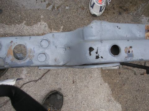 1988 Ford Bronco - A section of vehicle frame, painted gray, shows signs of rust and has several holes.