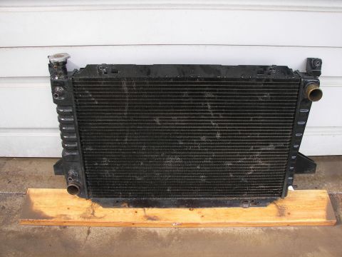 1988 Ford Bronco - Radiator assembly shown from the front, resting on wood planks.