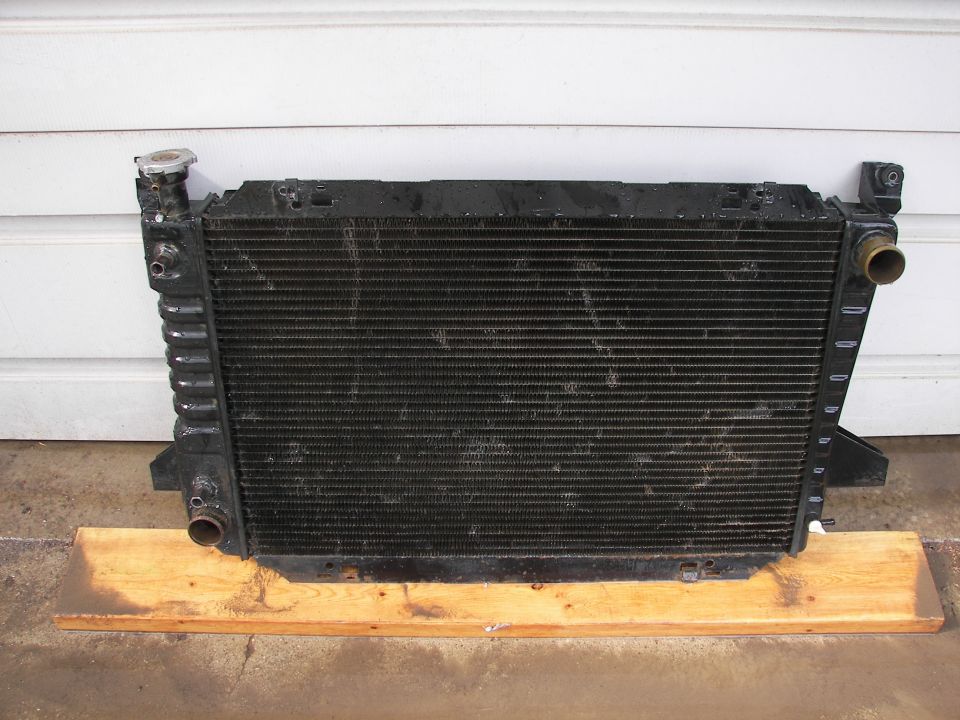 Radiator assembly with cap, mounted on wooden planks