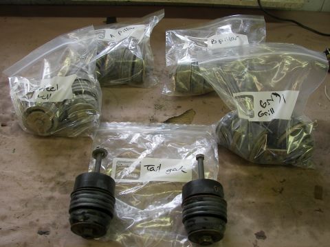 1988 Ford Bronco - Various vehicle parts, including A-pillar, B-pillar, wheel well, grill, and tail gate components, are organized in labeled plastic bags.