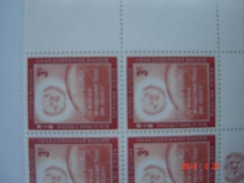 1993 Ford Bronco - A close-up view of four red postage stamps, each a globe and text.