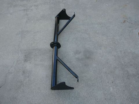 1988 Ford Bronco - This black metal automotive part is shown against a concrete background.