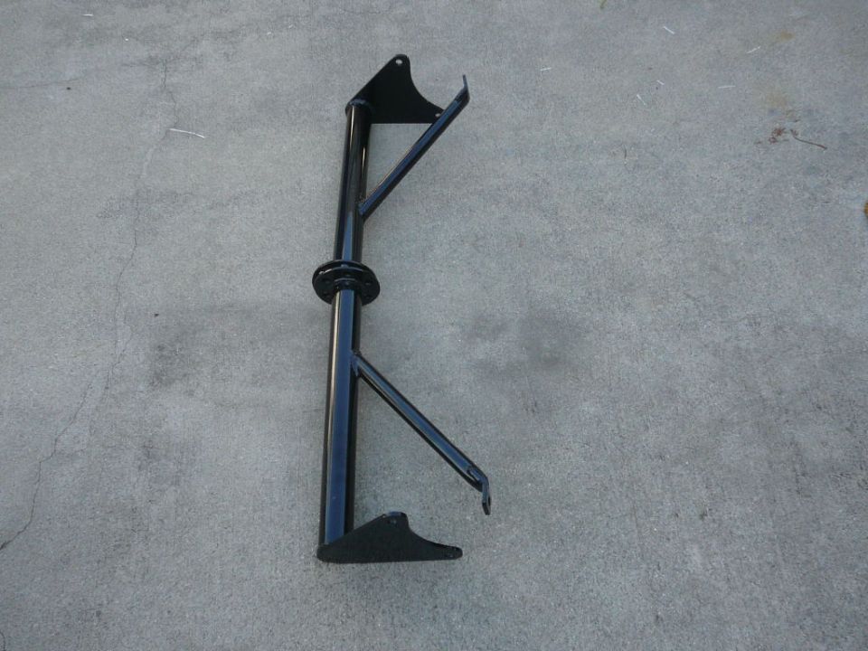 Black metal automotive part on concrete