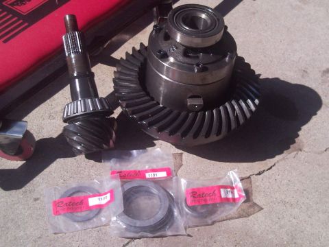 1989 Ford Bronco - Differential components, including a ring gear and pinion, are displayed with new bearing kits.