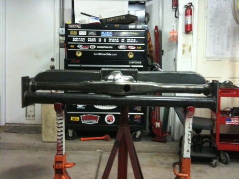 Suzuki Samurai - Custom rear axle assembly fabricated and supported by jack stands in a workshop setting.