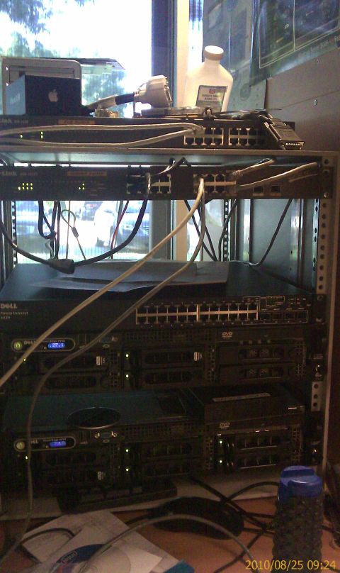 1985 Ford F-150 - A rack of network equipment, including switches and Dell servers, is visible in an office setting.
