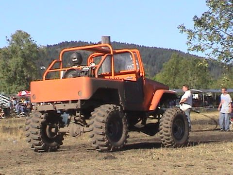 1994 Ford Explorer - Modified off-road buggy with custom roll cage and large tires at a mud drag event.