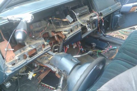 1991 Ford Crown Victoria - The interior of a 1991 Ford Crown Victoria shows a disassembled dashboard with numerous wires and components exposed.