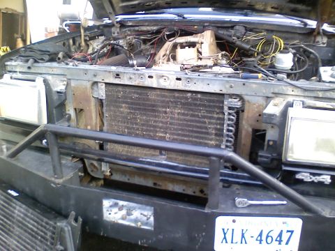 1990 Ford Bronco - Front view of a 1990 Ford Bronco's engine bay, the radiator and custom bumper.