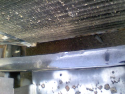 1990 Ford Bronco - The image shows a close-up view of a vehicle's radiator and front frame structure.