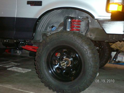 1996 Ford Bronco - A silver 1996 Ford Bronco is shown with its suspension modified for a lift kit.