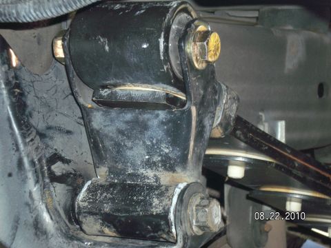 1996 Ford Bronco - A suspension component, likely a lift spacer, is shown attached to the vehicle's frame with bolts.
