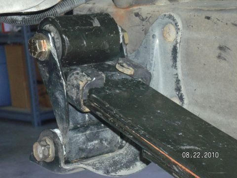 1996 Ford Bronco - Close-up of a vehicle's leaf spring and suspension bracket, showing a bolt and rubber bushing.