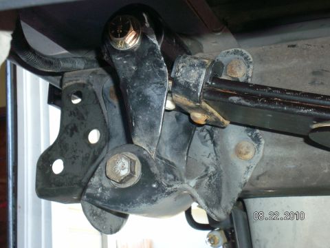 1996 Ford Bronco - Close-up view of a vehicle's suspension component, showing metal brackets and bolts.